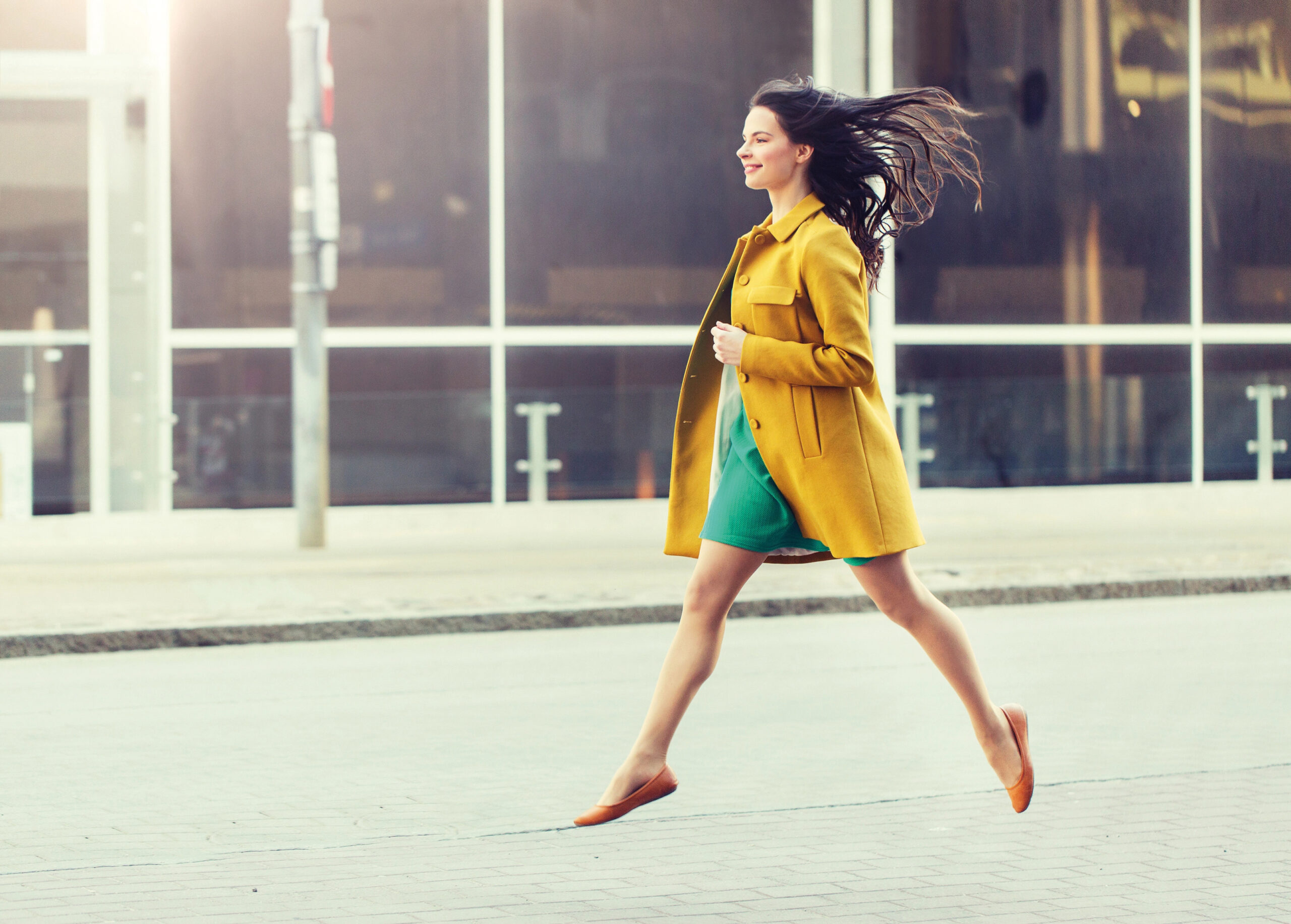 happy young woman or teenage girl on city street